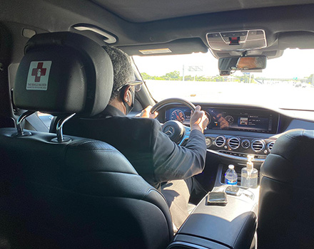 Photo of private chauffeur inside the car driving.