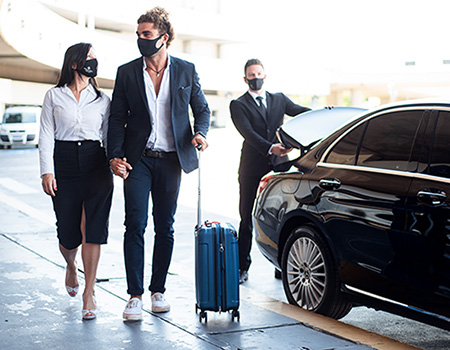 Chauffeur leaving couple with luggage at airport