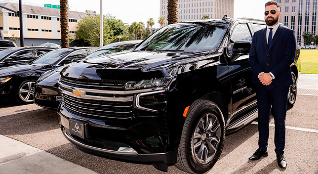 Luxury SUV chauffeur dropping off VIP guests at South Beach Wine and Food Festival