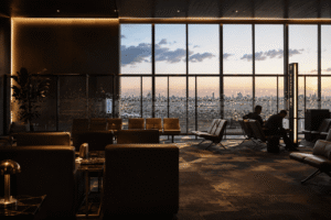 Luxurious VIP airport lounge at Benito Juárez International Airport (MEX) featuring elegant seating, warm ambient lighting, and floor-to-ceiling windows overlooking the airfield at sunset.